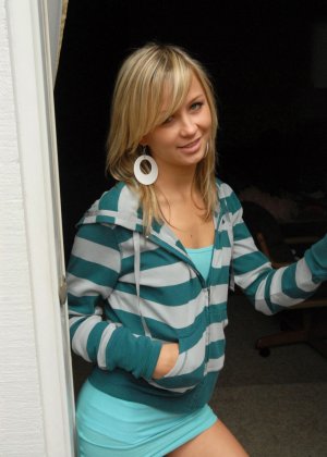 Молодая блондинка скачет по задней лестнице и патио в белых носках и нижнем белье