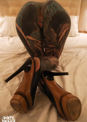 Сильно татуированная девушка сжимает свою киску кулаками после мастурбации секс-игрушкой